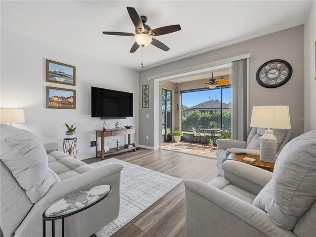a living room with furniture a large window and a flat screen tv
