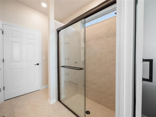 a bathroom with a glass shower door