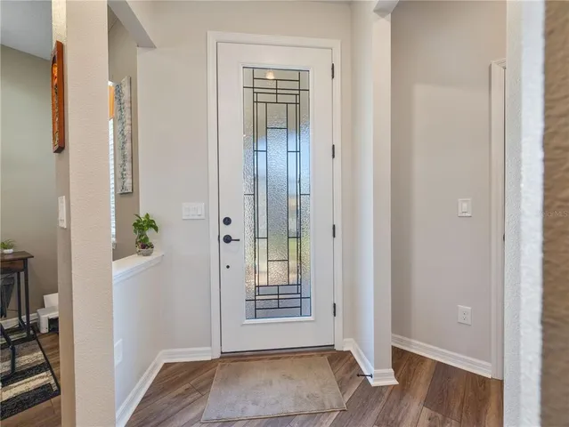 a view of an entryway with wooden floor