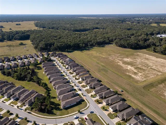 an aerial view of a house with yard swimming pool and outdoor seating