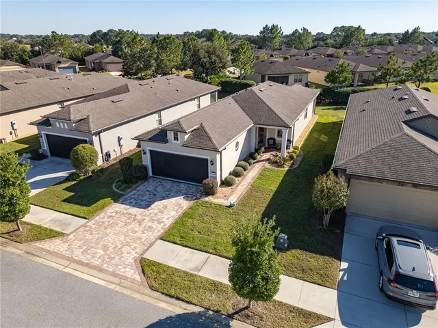 a front view of a house with a yard and a garage