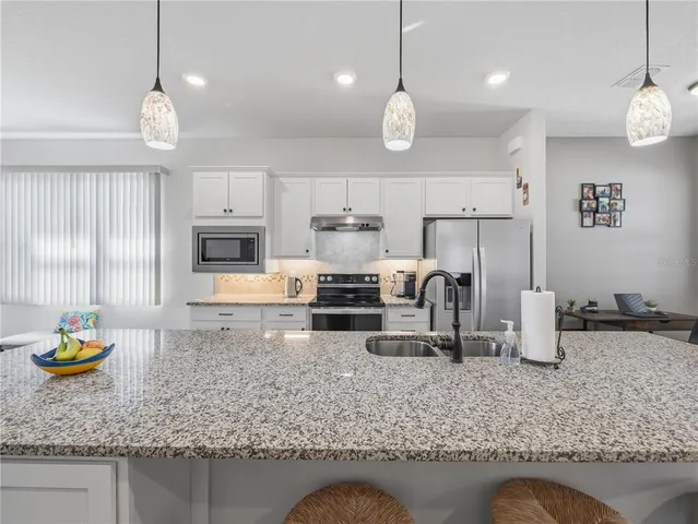 a kitchen with sink and refrigerator