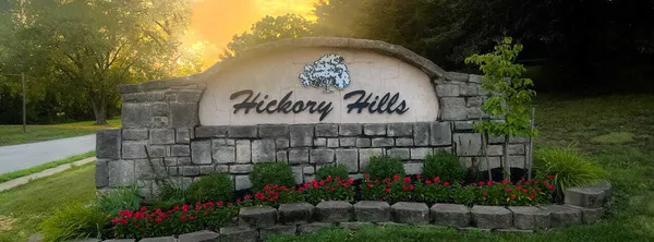 a sign that is in front of flowers