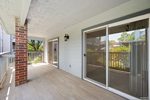 a park with large trees and lawn chairs