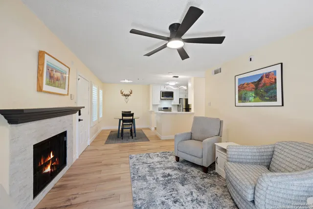 a living room with furniture and a fireplace