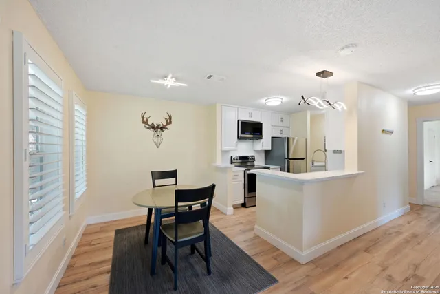 a view of kitchen with cabinets and wooden floor
