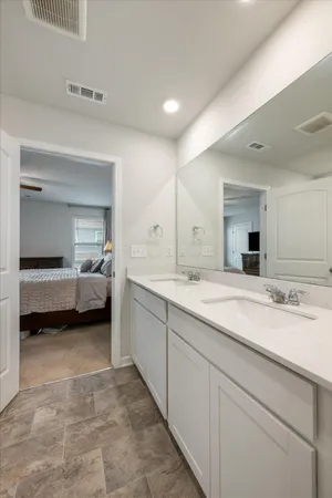 a spacious bathroom with a vanity and a mirror