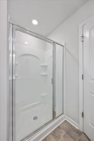 a bathroom with a glass shower door