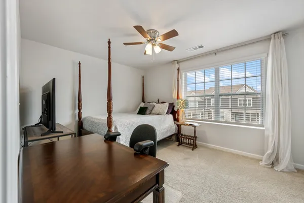 a bed room with a bed window and a flat screen tv