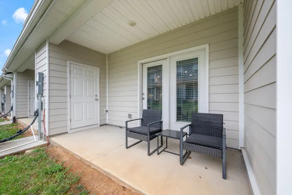 a balcony with furniture and a window