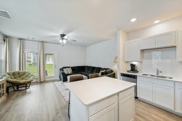 a kitchen that has a sink and a stove in it