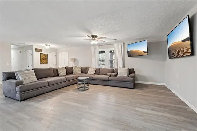a living room with furniture and a wooden floor