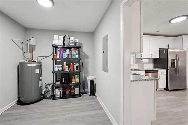 a view of a kitchen with fridge and wooden floor