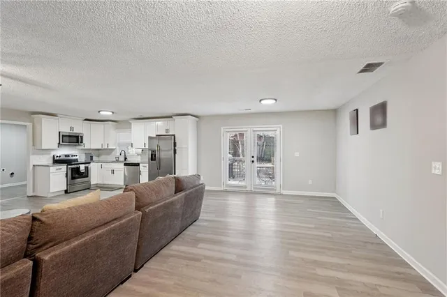a living room with furniture and kitchen view