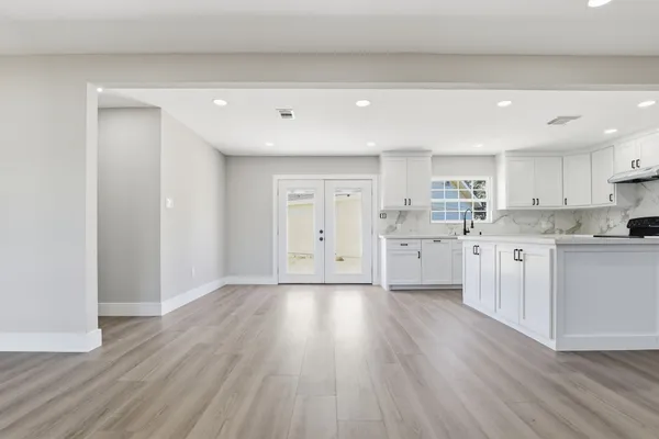 a view of a kitchen with a sink and wooden floor