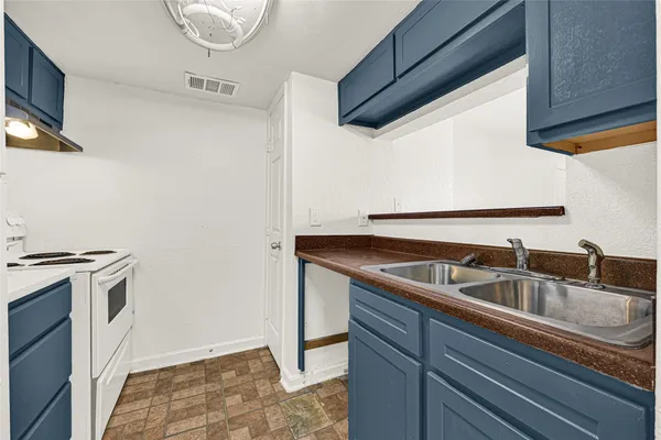a view white cabinets and a sink