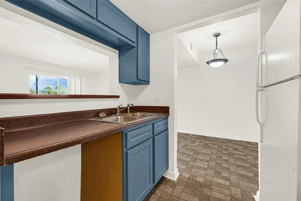 a kitchen with a sink and a refrigerator