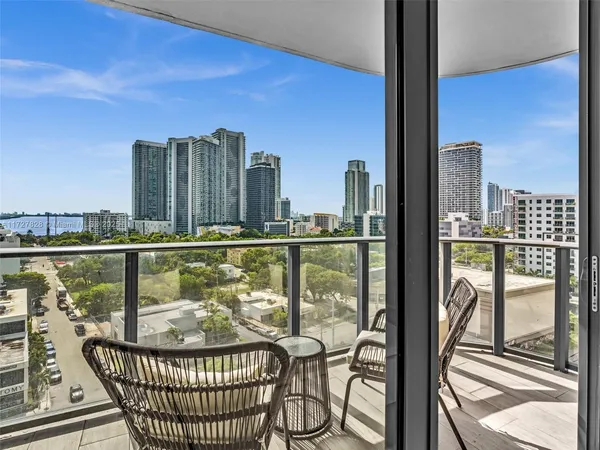 a view of balcony with a floor to ceiling window next to a road