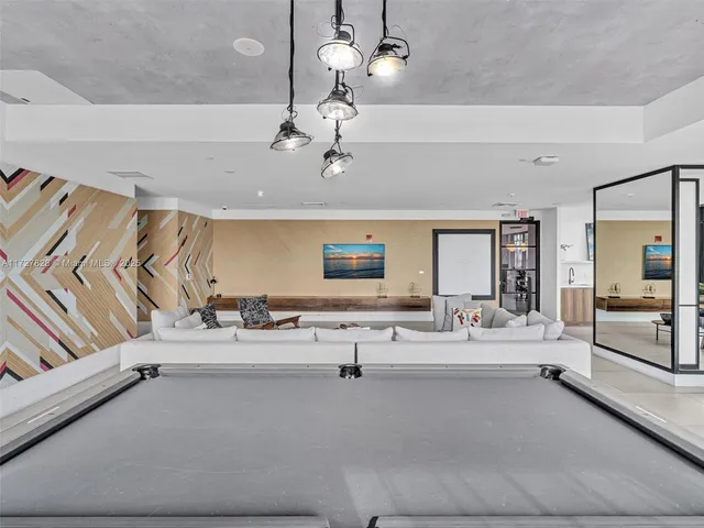 a living room with furniture and chandelier