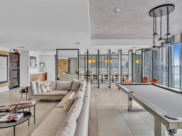 a living room with furniture and large windows