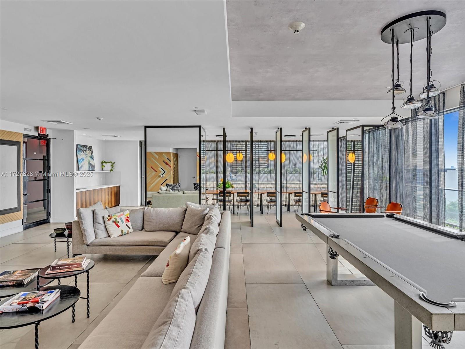 121 Northeast 34th Street, Unit 1005 Miami, FL 33137 - Photo 28 of 44 a living room with furniture and large windows