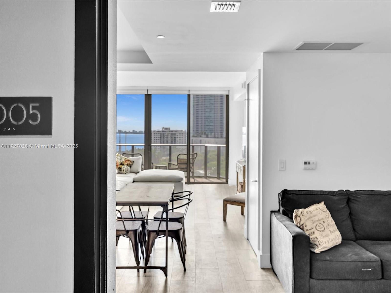 121 Northeast 34th Street, Unit 1005 Miami, FL 33137 - Photo 3 of 44 a living room with furniture and a large window