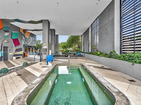 a swimming pool with outdoor seating and yard