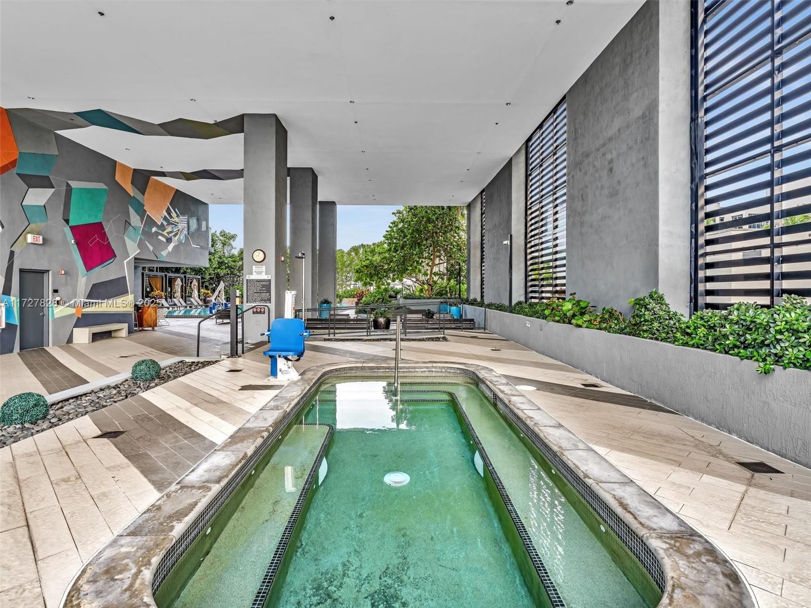121 Northeast 34th Street, Unit 1005 Miami, FL 33137 - Photo 34 of 44 a swimming pool with outdoor seating and yard