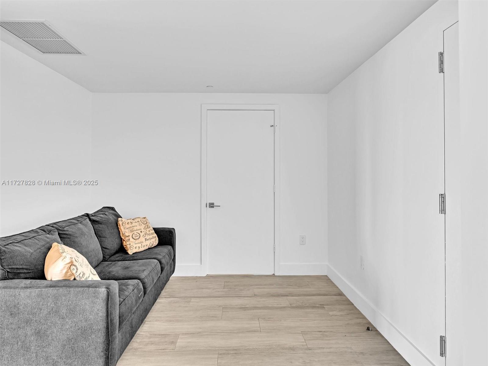 121 Northeast 34th Street, Unit 1005 Miami, FL 33137 - Photo 5 of 44 a living room with furniture and a couch