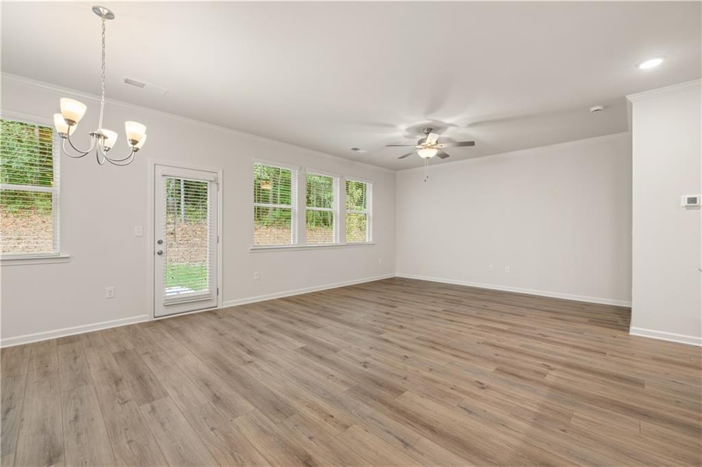 4516 Ajo Walk Atlanta, GA 30331 - Photo 12 of 13 a view of an empty room with a window and wooden floor