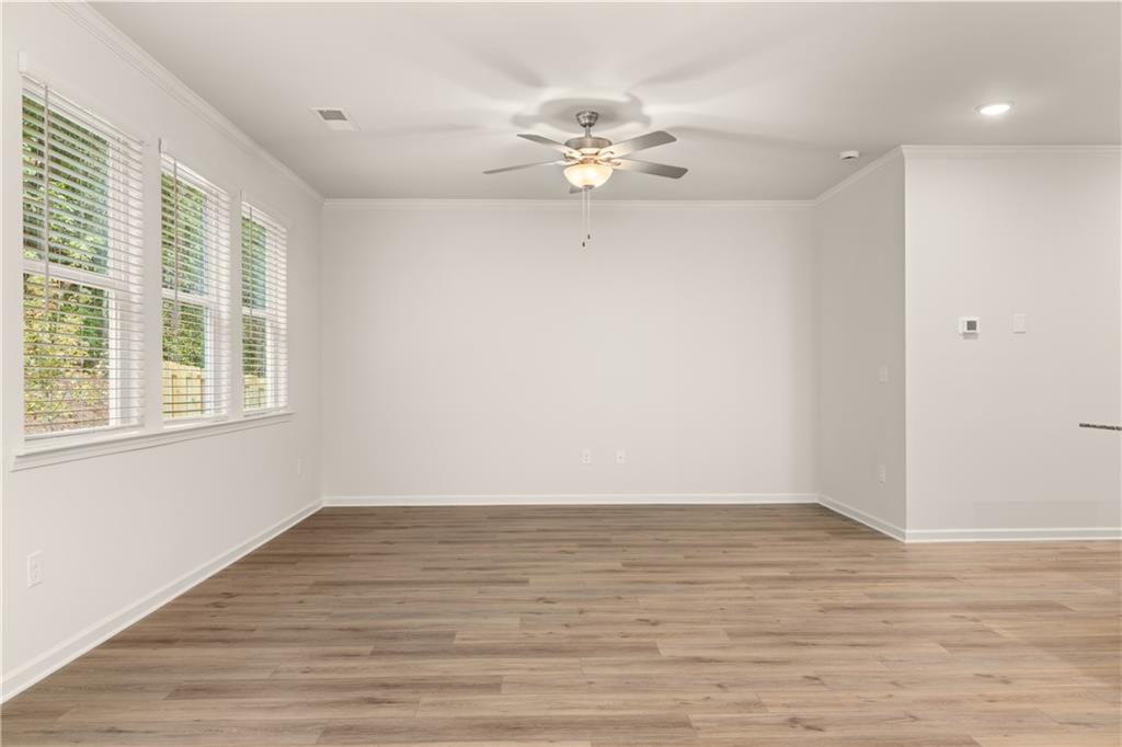 4516 Ajo Walk Atlanta, GA 30331 - Photo 13 of 13 a view of an empty room with wooden floor and a window