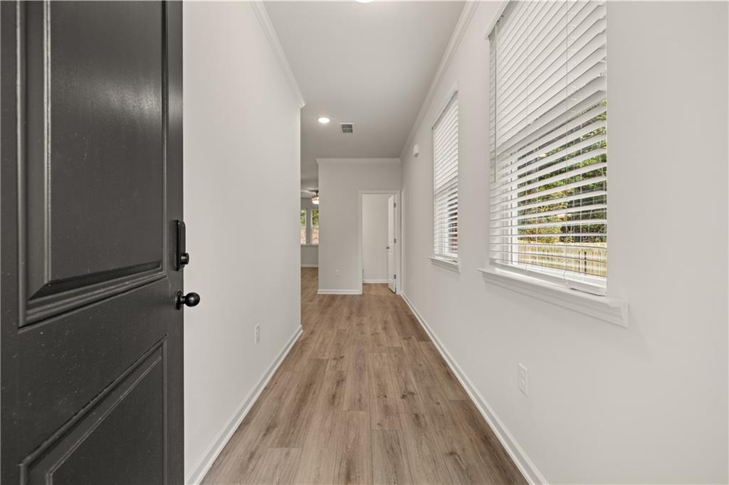 4516 Ajo Walk Atlanta, GA 30331 - Photo 2 of 13 a view of a hallway with wooden floor and a window