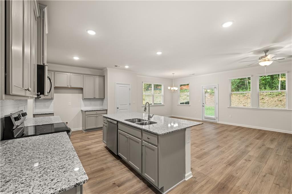 4516 Ajo Walk Atlanta, GA 30331 - Photo 4 of 13 a kitchen with stainless steel appliances granite countertop a sink stove and refrigerator
