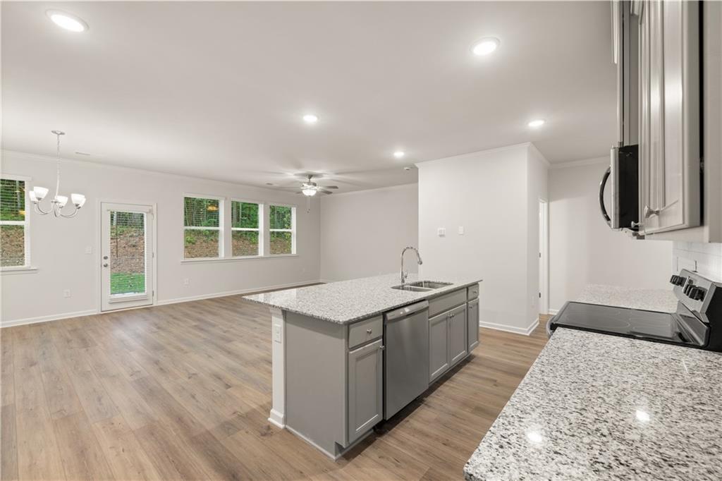 4516 Ajo Walk Atlanta, GA 30331 - Photo 8 of 13 a kitchen with a stove and a sink