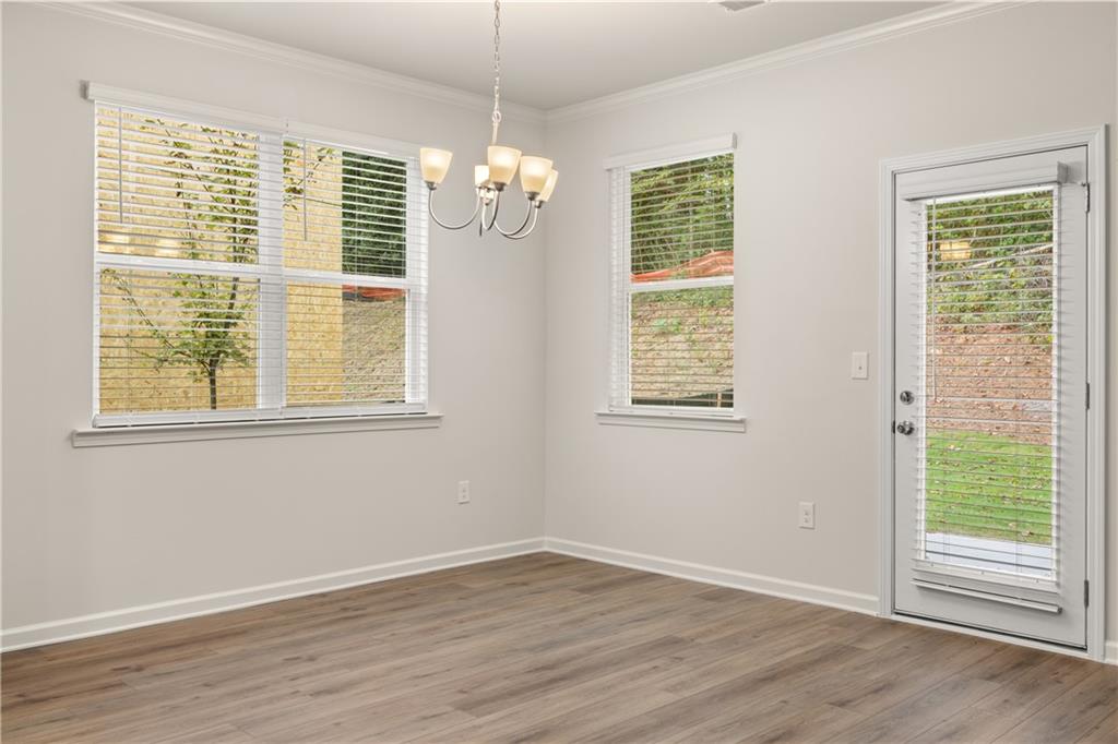 4516 Ajo Walk Atlanta, GA 30331 - Photo 10 of 13 a view of an empty room with wooden floor and a window