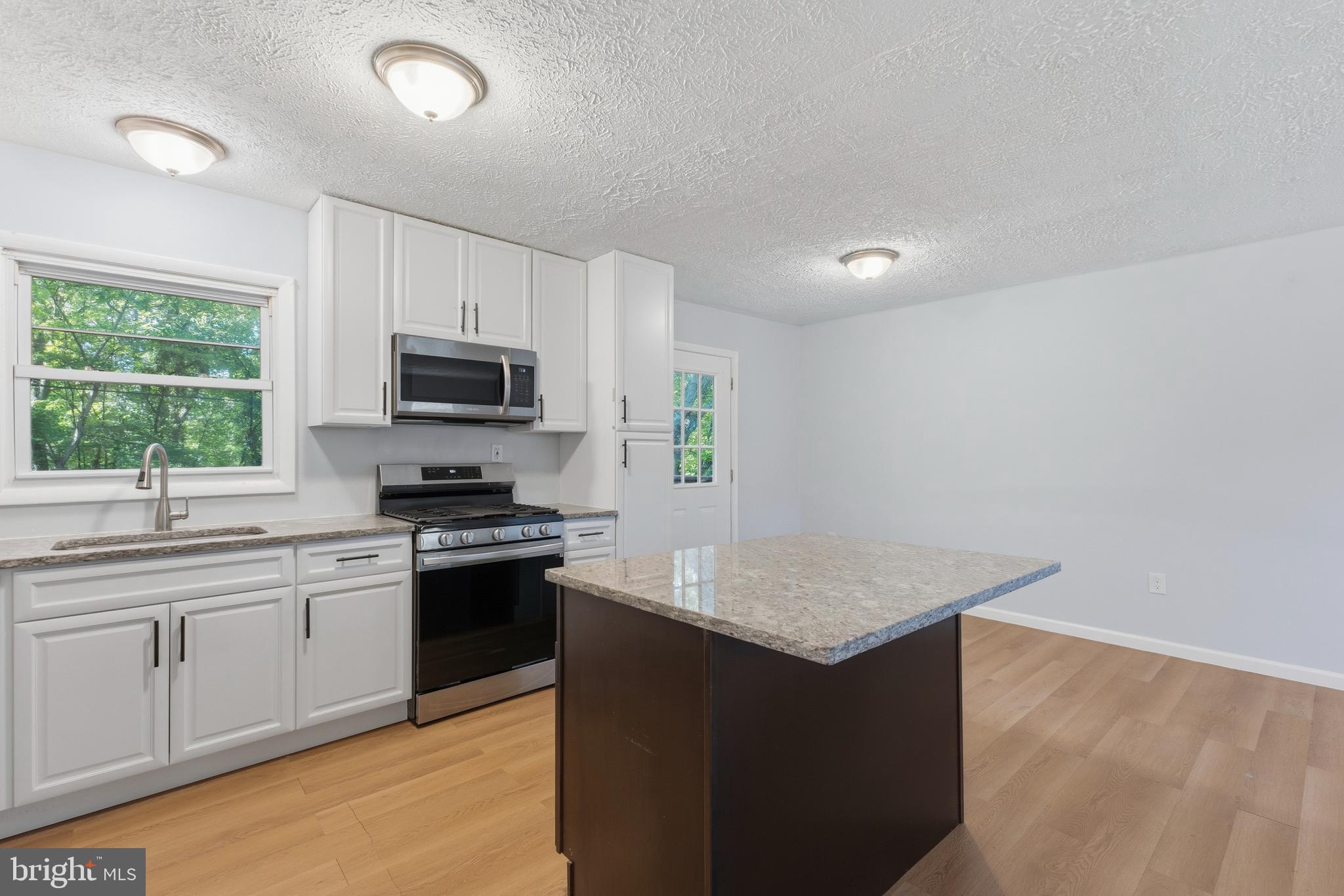 119 Jefferson Road Waldorf, MD 20602 - Photo 3 of 40 a kitchen with a sink stove and microwave