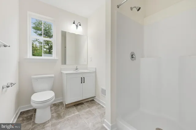 a white toilet sitting next to a bathroom sink