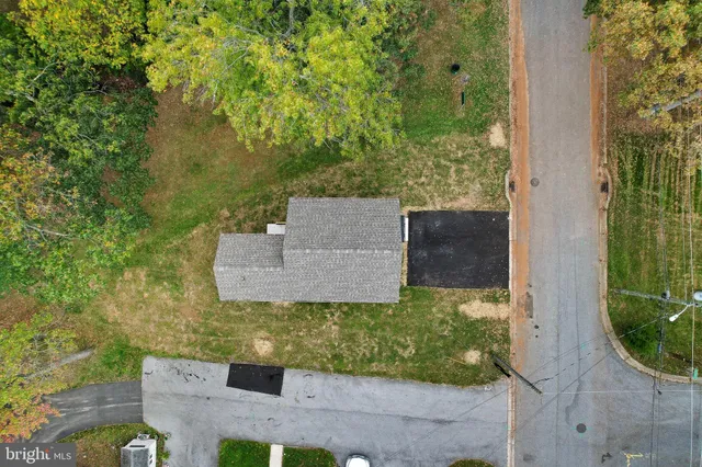 an aerial view of a house with a yard