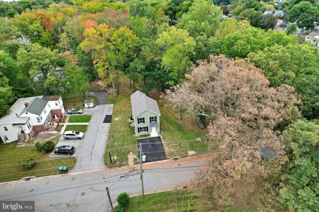 an aerial view of a house with a yard and garden