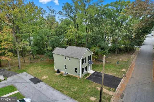 a view of a house with a yard and a patio