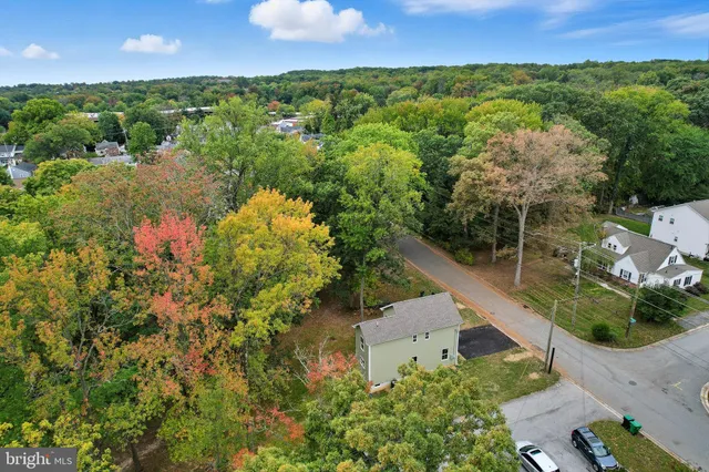 an aerial view of a house with a yard and lake view