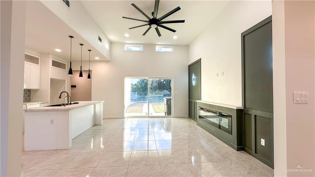 1509 Vida Dulce Weslaco, TX 78596 - Photo 4 of 24 a kitchen with stainless steel appliances a sink a stove a refrigerator and a window