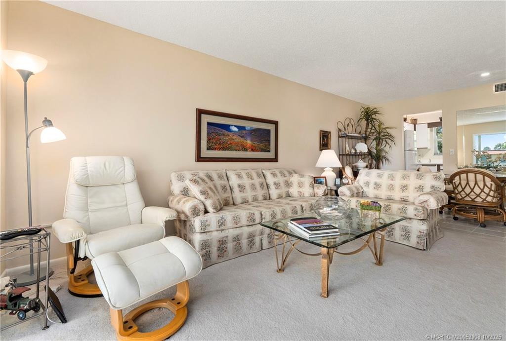 1913 Southwest Palm City Road, Unit 7F Stuart, FL 34994 - Photo 11 of 28 a living room with furniture a rug and a table