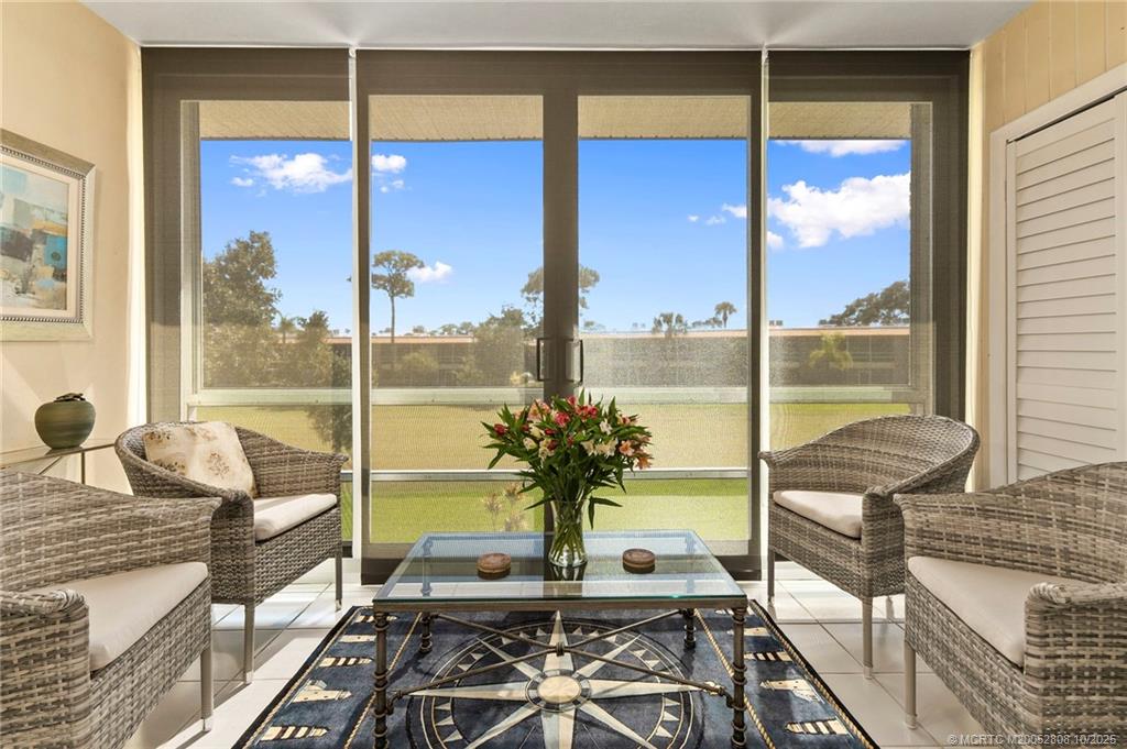 1913 Southwest Palm City Road, Unit 7F Stuart, FL 34994 - Photo 12 of 28 a view of a living room with furniture and floor to ceiling window