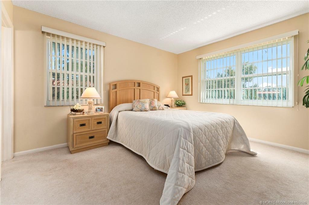 1913 Southwest Palm City Road, Unit 7F Stuart, FL 34994 - Photo 13 of 28 a bed room with a bed and a large window