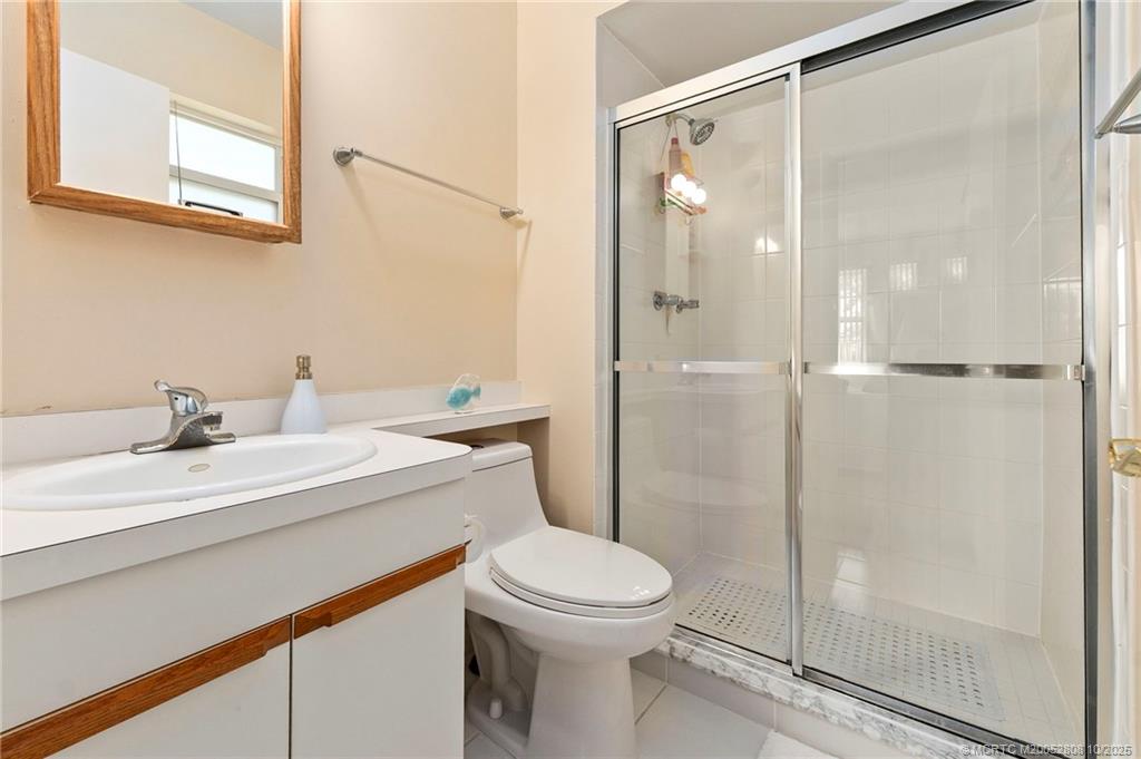 1913 Southwest Palm City Road, Unit 7F Stuart, FL 34994 - Photo 14 of 28 a bathroom with a sink a toilet and shower