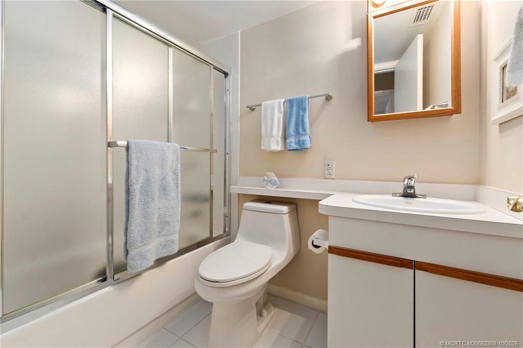 1913 Southwest Palm City Road, Unit 7F Stuart, FL 34994 - Photo 16 of 28 a bathroom with a toilet sink and shower