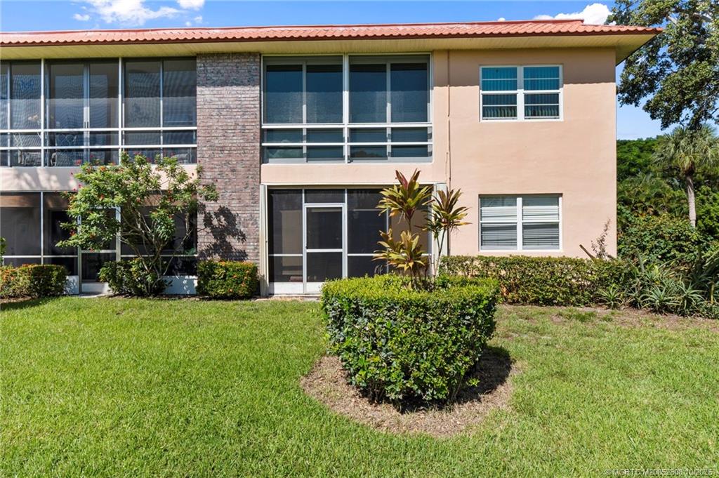 1913 Southwest Palm City Road, Unit 7F Stuart, FL 34994 - Photo 17 of 28 a front view of a house with garden