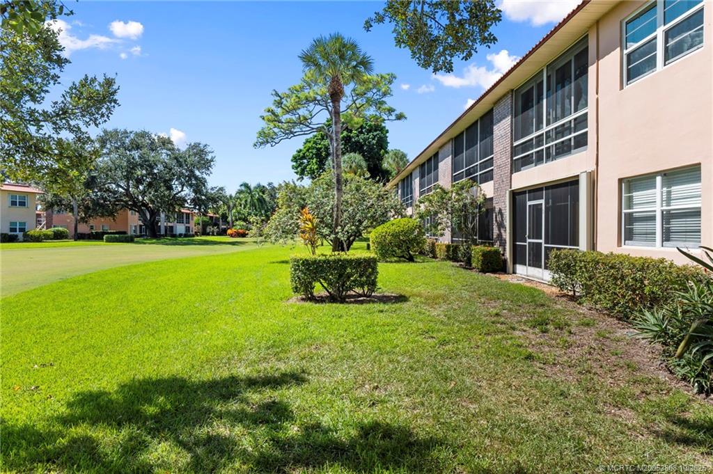 1913 Southwest Palm City Road, Unit 7F Stuart, FL 34994 - Photo 18 of 28 a view of a house with a yard and sitting area
