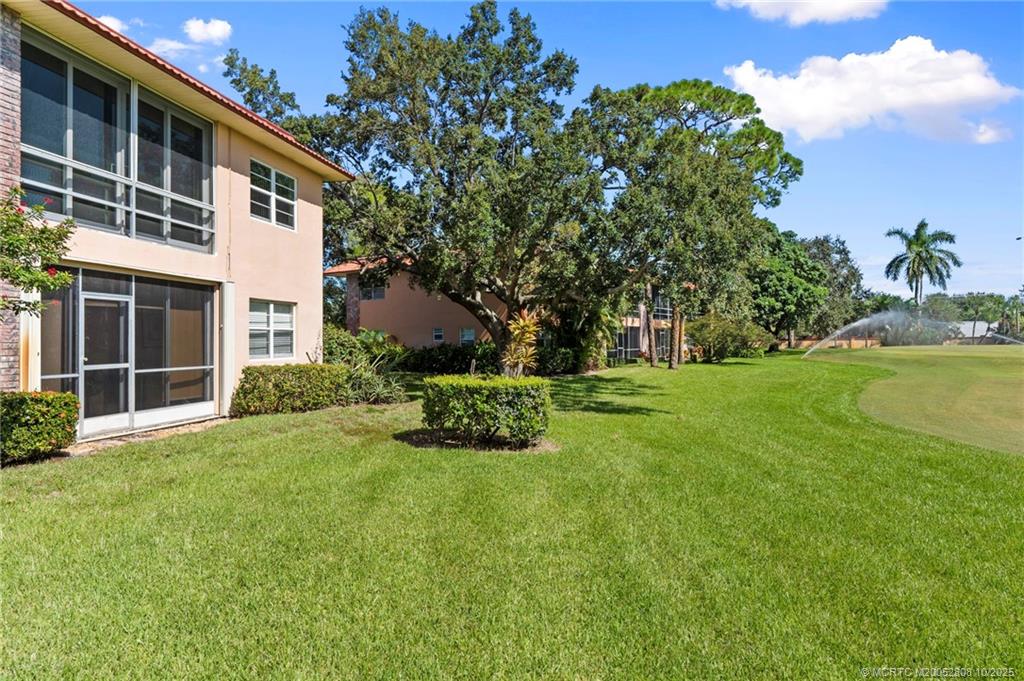 1913 Southwest Palm City Road, Unit 7F Stuart, FL 34994 - Photo 19 of 28 a front view of a house with a yard